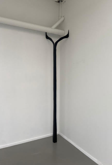 The ashes in the electric fireplace are still warm no. 7, 2025 <br><small>wood and tar, 280 x35 x 35 cm, €1750</small>